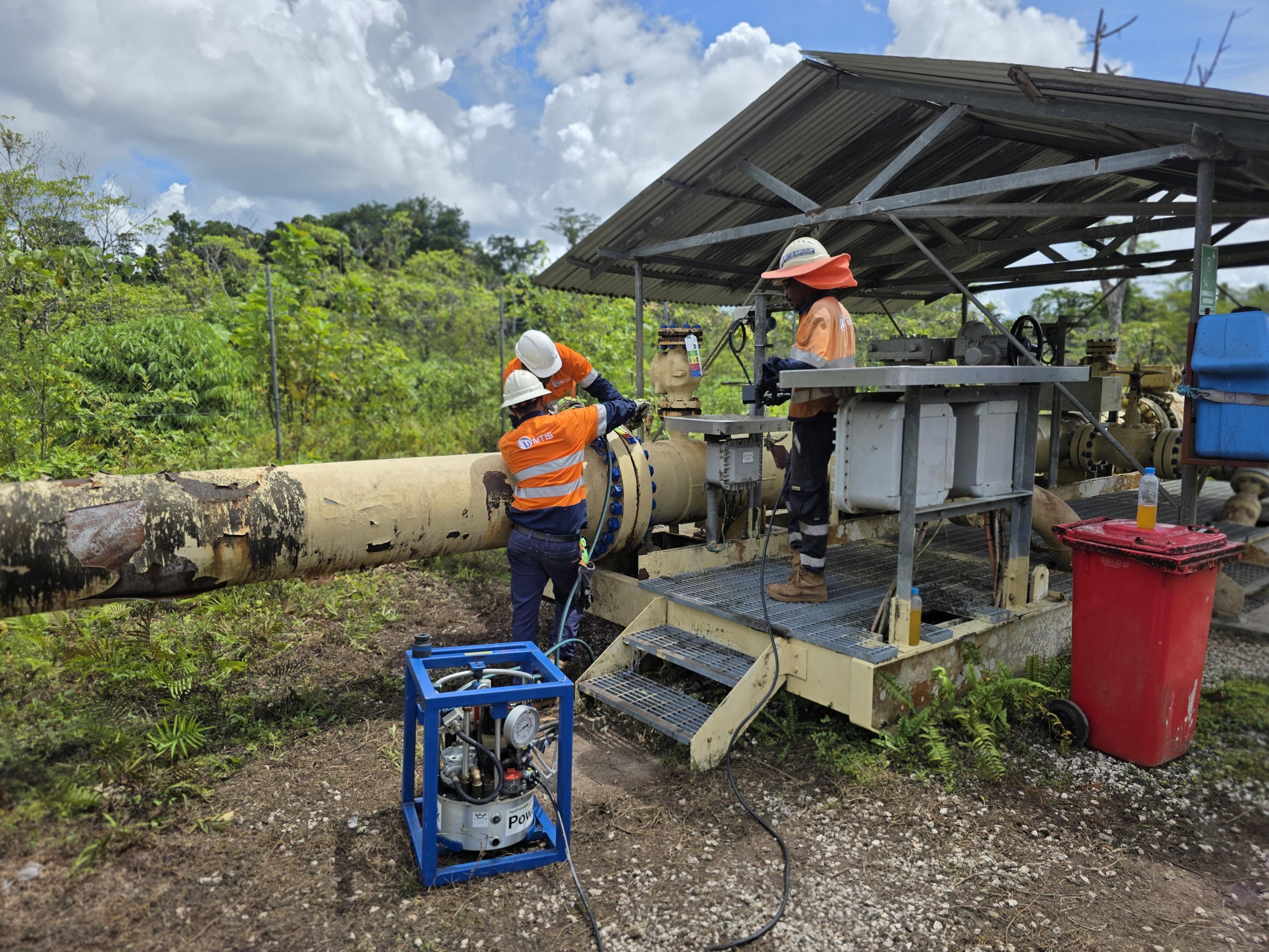 MTIS crew using hydraulic tensioning equipment for live flange maintenance on a gas pipeline in PNG